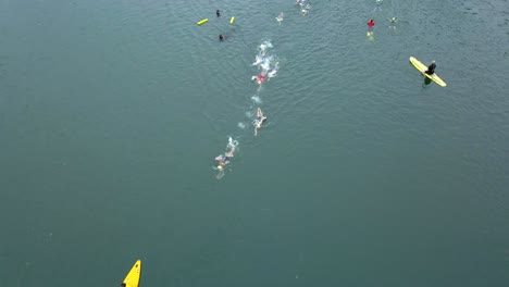 A-drone-captures-the-leaders-of-a-swim-race,-the-first-leg-of-a-triathlon