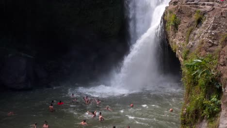 Tourists-enjoying-bath-in-natural-pool-under-Tegenungan-Waterfall-in-Bali