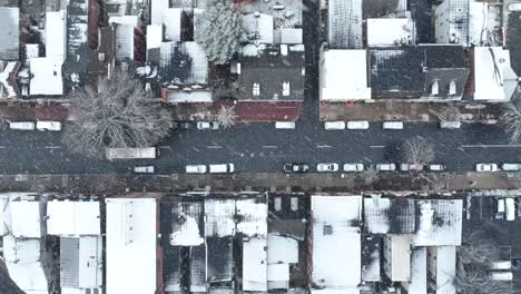 Top-down-aerial-of-city-street-with-snow-flurries