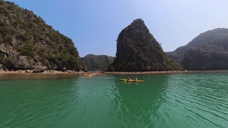 A-group-of-People-kayaking-towards-the-islands-of-vietnam-in-the-Ha-long-Bay