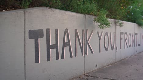 Thank-you,-Frontline-wall-art-mural-in-Austin,-Texas-close-up-pan-across