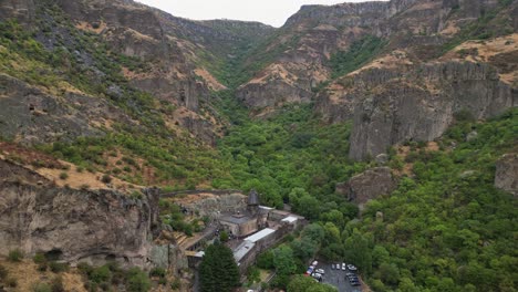 Aerial-retreats-from-Geghard-Monastery-in-Azat-River-gorge,-Armenia