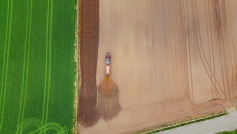 Top-down-shot-of-a-farmer-spraying-his-field-with-fertiliser-to-aid-crop-growth