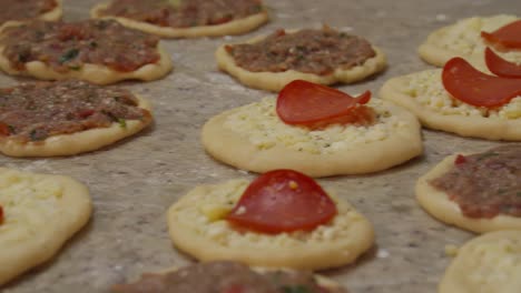 Raw-pizza-like-bread-with-ground-beef-and-pepperoni-and-cheese-toppings---Raw-esfiha