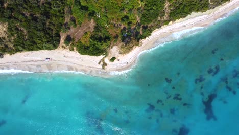 Drone-shot-of-the-Albanian-coast-in-the-Mediterranean-sea---drone-is-hovering-birds-eye-view-over-a-lonely-beach