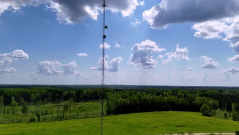 Skujene,-Latvia,-Europe---Towers-Positioned-Among-the-Lush-Green-Landscape---Pan-Up-Shot