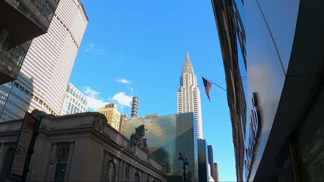 Grand-Central-station-and-Empire-state-building-with-USA-flag-in-front