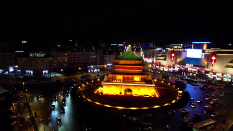 Bell-Tower-in-Xi'an-illuminated-at-night-surrounded-by-busy-traffic-and-city-lights,-China