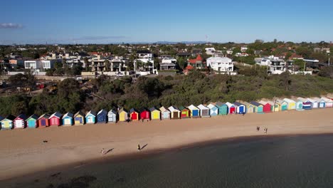 Drone-Shot-of-Brighton-Bathing-Boxes,-Dendy-Street-Beach-on-Sunny-Day,-Melbourne-Australia