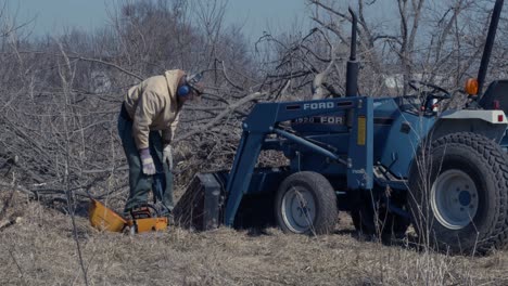 Slow-motion-shot-of-a-lumberjack-putting-a-protective-sheath-on-his-chainsaw