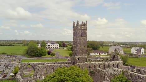 Claregalway-Friary-at-center-of-overcast-sky-as-drone-orbit-and-ascends