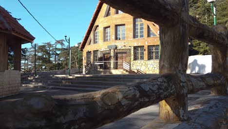 Close-up-footage-of-Wooden-building-in-park,and-Cedrus-trees-from-behind,-in-chrea,blida--algeria