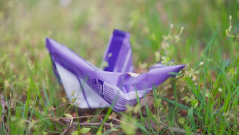 Plastic-candy-wrapper-thrown-into-nature,-environment-pollution,-Czechia