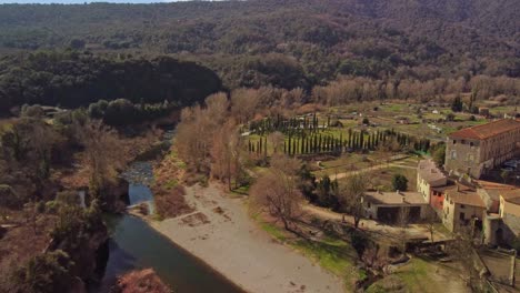 Besalu-town-in-girona,-spain-with-surrounding-nature-and-river,-aerial-view