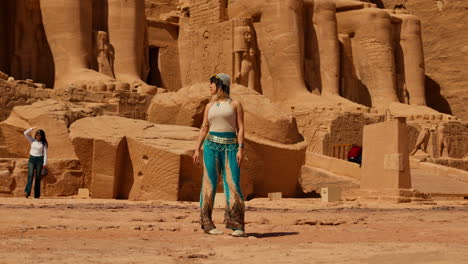Tourist-Posing-at-the-entrance-of-Great-Temple-of-Ramses-II,-Abu-Simbel