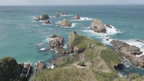 View-of-rock-formations-in-the-ocean-at-Nugget-Point-in-New-Zealand-on-a-sunny-day