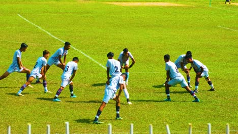 Junior-Division-Football-Players-Warming-Up-Before-the-Match-With-Exercises---Wide-Shot