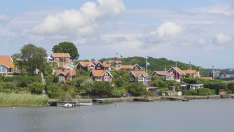 Red-Seaside-Summer-Houses-During-Summer-at-Brandaholm,-Karlskrona,-Sweden