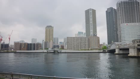 Slow-reveal-of-tokyo-canals-and-bridge-on-overcast-day