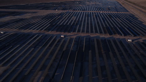 Aerial-View-of-Solar-Power-Plant-at-Twilight,-Massive-Arrays-of-Solar-Panels,-Drone-Shot
