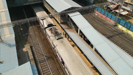 Transporte-En-Tren-De-Mumbai,-Tiro-De-Sobrevuelo-Con-Drones,-Viaje-En-Tren-En-La-India