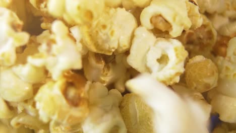 Popcorn-falling-into-big-bucket,-delicious-close-up-beauty-shot