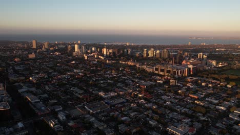 Aerial-View-of-Melbourne-Australia-Suburbs,-Residential-and-Commercial-Buildings-on-Golden-Hour-Sunlight