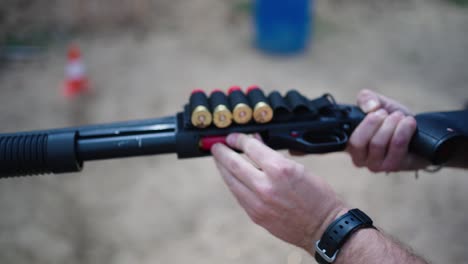 Male-insert-combat-ammunition-into-shotgun-barrel-chamber,-Czech-Republic