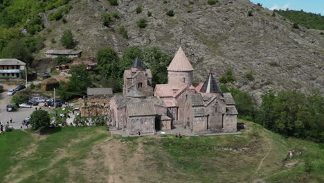 Low-aerial-orbits-Goshavank-Monastery-as-tourists-explore-the-grounds