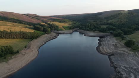 Aerial-Drone-Flight-over-Errwood-Reservior-in-Goyt-Valley-Buxton-showing-very-low-water-levels-during-a-heatwave-in-the-United-Kingdom