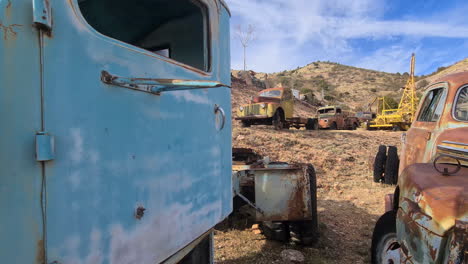 Old-Rusty-Trucks-in-Desert-Landscape,-Jerome-Ghost-Town,-Arizona-USA
