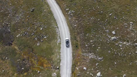 Aerial-Drone-Top-Down-View-of-Car-Driving-on-a-Vikafjell-Road,-a-Mountain-in-Western-Norway