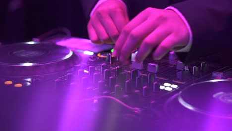 Hands-Of-Dj-Moving-Controls-On-Record-Deck-In-Night-Club,-up-close