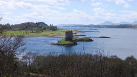 Scenic-view-of-Castle-Stalker-on-rocky-outcrop-surrounded-by-water-in-Argyll-near-Oban,-Scotland-UK