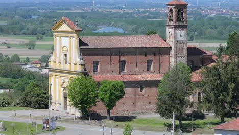 rising-aerial-of-Church-of-Saint-Peter-Apostle-and-the-surrounding-countryside-in-Gabiano,-Italy,-Piedmont-region