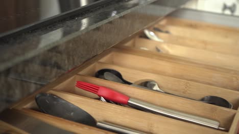 Putting-back-utensil-in-a-kitchen-drawer