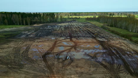 Aerial-view-of-deforested-land-for-solar-field-setup,-transforming-the-landscape