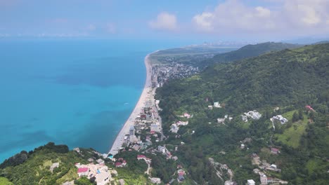 An-aerial-view-of-a-coastal-town-with-a-stunning-blue-sea-stretching-out-to-the-horizon