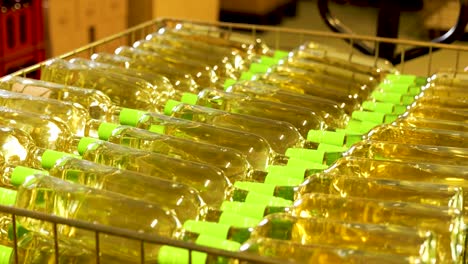 White-Wine-Bottles-with-Green-Caps-in-a-Bottling-Line