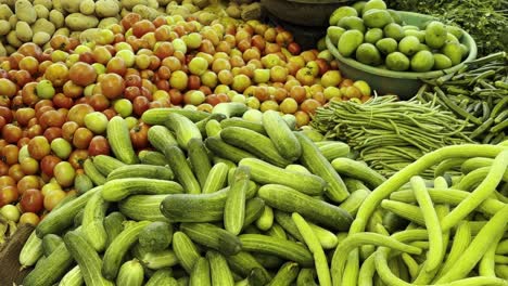 street-vender-is-selling-a-variety-of-fresh-vegetable-like-cucumber,-tomato,-potato,-drumstick,-Brinjal-and-bottle-gourd-in-vegetable-market,-Farmers-market,-sabzi-mandi