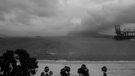 Epic-and-Cloudy-Scene-Sea-Port-and-Beach-with-Cranes