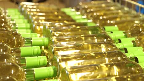 Rows-of-White-Wine-Bottles-with-Green-Caps-Ready-for-Packaging