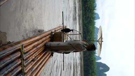 Chinese-Hanfu-girl-with-umbrella-openning-arms-on-bamboo-raft-in-Li-River