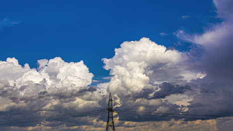 High-Voltage-Electrical-Transmission-Tower-With-Moving-Dense-Clouds-Background