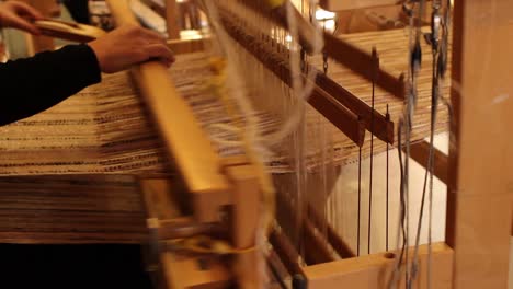 Woman-uses-an-old-loom-to-make-a-tapestry-in-an-artisan-shop-in-the-country-of-Israel