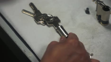 A-man-making-a-lock-fit-a-key