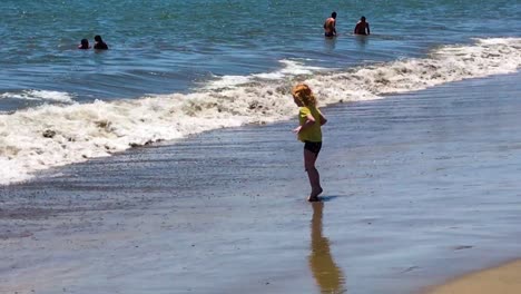Little-Girl-Playing-with-waves-and-enjoying-on-Tropical-Exotic-Sea-Coastline