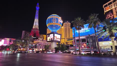 Nighttime-scene-of-bustling-traffic-in-front-of-The-Paris-Las-Vegas-Hotel-and-Casino,-on-the-famous-Las-Vegas-Strip-in-Nevada