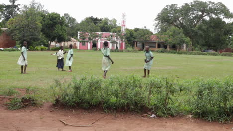 Uganda-children-playing-with-ball-on-green-meadow-in-school-area