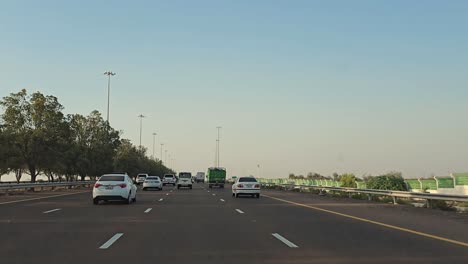 Traffic-navigates-through-Abu-Dhabi-E11-Sheikh-Maktoum-Bin-Rashid-road-towards-Dubai-on-the-third-lane,-which-is-limited-to-drivers-with-a-speed-limit-of-100-km-and-below